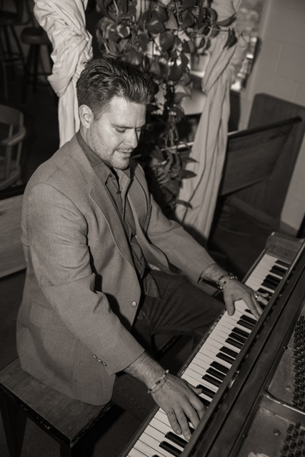 Curtis McLeod playing piano during an event